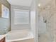 Bathroom featuring a soaking tub with a window view and a walk-in glass shower at 4224 Galapagos Ave, North Las Vegas, NV 89084