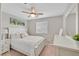 Cozy bedroom with white bedding, a ceiling fan, and a mirrored dresser at 4224 Galapagos Ave, North Las Vegas, NV 89084