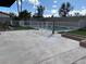 A large concrete patio surrounds a pristine pool, complemented by lush artificial turf and planter boxes at 4417 De Forest St, Las Vegas, NV 89103