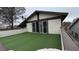 Exterior view of an upper-level balcony with sliding glass doors overlooking artificial turf at 4417 De Forest St, Las Vegas, NV 89103