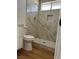 Bathroom showcasing a tiled shower, modern fixtures, and stylish herringbone pattern drain at 4417 De Forest St, Las Vegas, NV 89103
