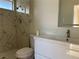 Bathroom featuring a tiled shower, modern vanity, and stylish herringbone pattern drain at 4417 De Forest St, Las Vegas, NV 89103