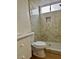 Bathroom featuring updated tile shower, white vanity, and modern fixtures at 4417 De Forest St, Las Vegas, NV 89103