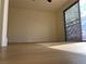Bright bedroom featuring wood floors and a sliding glass door providing access to the outdoors at 4417 De Forest St, Las Vegas, NV 89103