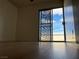 Bright bedroom featuring wood floors and a sliding glass door providing access to the outdoors at 4417 De Forest St, Las Vegas, NV 89103