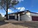 Charming single Gathering home with a two car garage, mature tree, and beautiful blue sky at 4417 De Forest St, Las Vegas, NV 89103