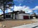 Charming single Gathering home with a two car garage, mature tree, and beautiful blue sky at 4417 De Forest St, Las Vegas, NV 89103