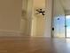 Hallway featuring clean white walls, hardwood floors, and access to an exterior sliding glass door at 4417 De Forest St, Las Vegas, NV 89103