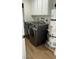 Convenient laundry room featuring a modern washer, dryer, and water heater at 4417 De Forest St, Las Vegas, NV 89103