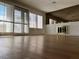 Living room boasts hardwood floors, bright windows, and a brick fireplace with a large mirror above at 4417 De Forest St, Las Vegas, NV 89103