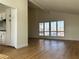 Spacious living room with wood floors and bright shuttered windows that let in natural light at 4417 De Forest St, Las Vegas, NV 89103
