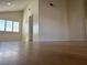 Bright living room with hardwood floors, window shutters, and views into the kitchen at 4417 De Forest St, Las Vegas, NV 89103