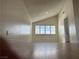 Bright, neutral living room with high ceiling and window shutters overlooking the neighborhood at 4417 De Forest St, Las Vegas, NV 89103