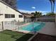 Backyard oasis with sparkling pool surrounded by well-maintained artificial grass at 4417 De Forest St, Las Vegas, NV 89103