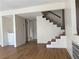Bright and spacious staircase featuring white walls, modern lighting, and wood flooring at 4417 De Forest St, Las Vegas, NV 89103