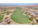 Panoramic aerial view of a golf course community, highlighting the lush fairways and varied home styles at 505 Punto Vallata Dr, Henderson, NV 89011
