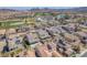 Stunning aerial view of homes near a golf course, featuring a swimming pool and mountain views in the distance at 505 Punto Vallata Dr, Henderson, NV 89011