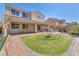 Spacious backyard with artificial turf, brick paved patio, and outdoor furniture ready for entertaining at 505 Punto Vallata Dr, Henderson, NV 89011