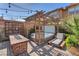 Relaxing backyard featuring a hot tub, fire pit, lounge chair, and brick pavers, perfect for outdoor enjoyment at 505 Punto Vallata Dr, Henderson, NV 89011