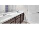 Modern bathroom boasting dual sinks, dark cabinets, and a large mirror offering a functional design at 505 Punto Vallata Dr, Henderson, NV 89011
