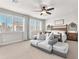Primary bedroom suite features a plush sofa, ceiling fan, and lots of natural light at 505 Punto Vallata Dr, Henderson, NV 89011