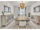 Bright dining room with an elegant chandelier, modern decor, and seating for eight at 505 Punto Vallata Dr, Henderson, NV 89011