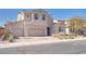 Charming stucco home featuring a three-car garage, landscaped yard, and a welcoming facade at 505 Punto Vallata Dr, Henderson, NV 89011