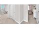 Bright hallway showcasing neutral paint, carpet, and baseboards throughout the home's interior at 505 Punto Vallata Dr, Henderson, NV 89011