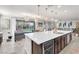 Bright, open kitchen with a large island, modern lighting, and stainless steel appliances perfect for entertaining and Gathering gatherings at 505 Punto Vallata Dr, Henderson, NV 89011