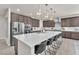 Spacious kitchen features an oversized island with seating, stainless appliances, and modern cabinetry at 505 Punto Vallata Dr, Henderson, NV 89011