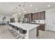 Elegant kitchen featuring a large island with seating, modern pendant lights and open concept layout at 505 Punto Vallata Dr, Henderson, NV 89011
