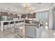 Open-concept kitchen featuring a large island with seating, modern lighting, and stainless steel appliances for a chef-inspired experience at 505 Punto Vallata Dr, Henderson, NV 89011