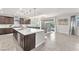 Open-concept kitchen boasts a large center island, modern appliances, and sliding glass doors to the backyard at 505 Punto Vallata Dr, Henderson, NV 89011
