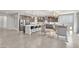 A spacious kitchen with a large central island, modern appliances, and an adjacent seating area that seamlessly blends living spaces at 505 Punto Vallata Dr, Henderson, NV 89011