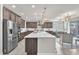 Contemporary kitchen featuring a large island, stainless steel appliances, and stylish pendant lighting at 505 Punto Vallata Dr, Henderson, NV 89011