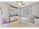 Bright office area with storage shelves, decorated buffet and seating area with natural light from the shuttered windows at 505 Punto Vallata Dr, Henderson, NV 89011