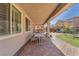 Covered patio with brick paving, offering an outdoor dining area and view of the well maintained backyard at 505 Punto Vallata Dr, Henderson, NV 89011