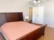 Bedroom with a wooden bed frame, overhead light, and a double door closet at 5117 Eldora Ave # 4, Las Vegas, NV 89146