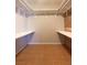 Walk-in closet with installed shelving and wood floors at 5117 Eldora Ave # 4, Las Vegas, NV 89146
