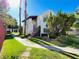 Well-maintained exterior building with archways, tiled roof, mature landscaping, and walking paths at 5117 Eldora Ave # 4, Las Vegas, NV 89146