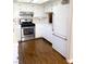 Bright kitchen with stainless steel appliances, tile backsplash, and white cabinets at 5117 Eldora Ave # 4, Las Vegas, NV 89146