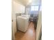 Bright laundry room with a washer, dryer, white cabinets, and a window at 5117 Eldora Ave # 4, Las Vegas, NV 89146