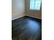 An uncluttered bedroom space featuring wood-look flooring and a window at 5220 Mission Carmel Ln # 103, Las Vegas, NV 89107
