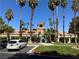 A clubhouse surrounded by towering palm trees and parking space at 5220 Mission Carmel Ln # 103, Las Vegas, NV 89107