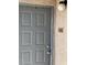 A close up of the gray front door of apartment #103 at 5220 Mission Carmel Ln # 103, Las Vegas, NV 89107