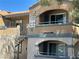 Tan two-story condo complex with Mission Carmel address signage and tiled roofing at 5220 Mission Carmel Ln # 103, Las Vegas, NV 89107