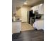 A compact kitchen design featuring white cabinets, stainless appliances, and tile floors at 5220 Mission Carmel Ln # 103, Las Vegas, NV 89107
