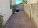 A gravel backyard features a block wall, an A/C unit and minimal landscaping at 5309 Luna Bonita St, Las Vegas, NV 89113