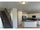 Open kitchen featuring white cabinetry, stainless steel appliances, and breakfast bar island at 5309 Luna Bonita St, Las Vegas, NV 89113