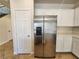 Modern kitchen featuring stainless steel refrigerator, white cabinets, and ample storage space at 5309 Luna Bonita St, Las Vegas, NV 89113